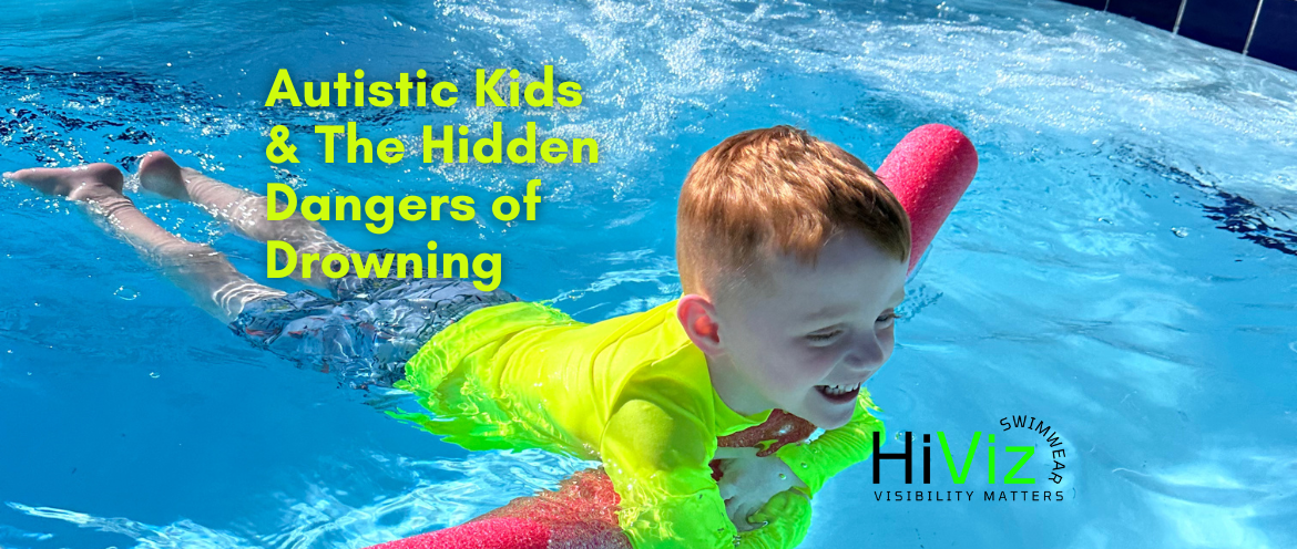 Four-year-old boy swimming in a blue pool with blue shorts and a neon rash guard. Neon Rash guards and neon swimwear make Autistic children stand out agains their surroundings adding a level of water-safety, enhanced supervision,  for this at-risk group.
