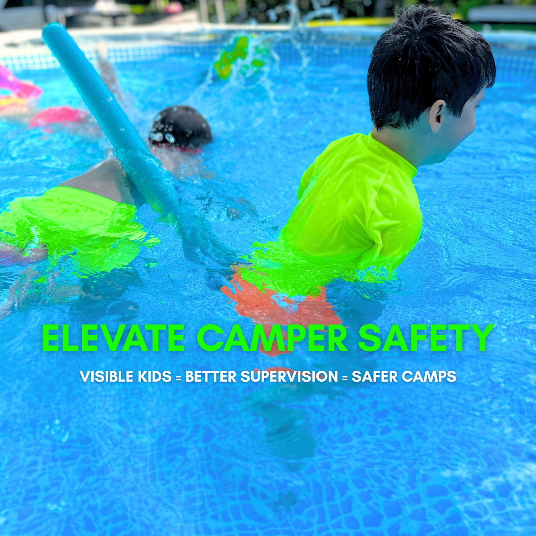 Two kids in neon swimwear playing in a swimmin gpool with text about camper safety.