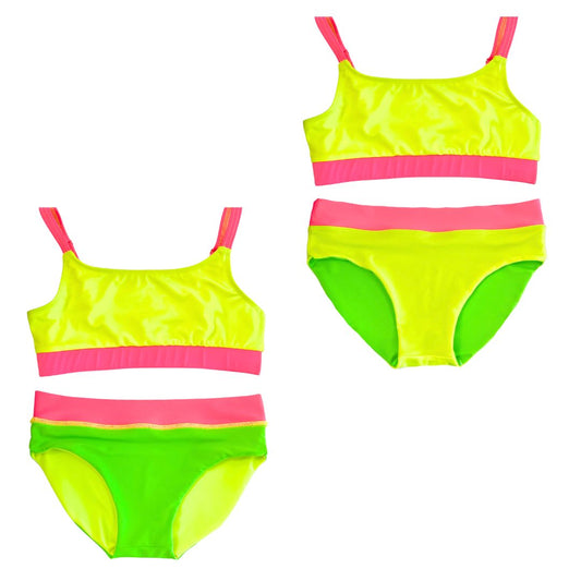 Girls's bright swimsuit featuring neon yellow and neon pink accents, along with reversible bikini bottoms in neon yellow and neon green. This hi vis swimsuit/neon swimsuit is designed for high visibility, allowing the swimmer to stand out from any background."