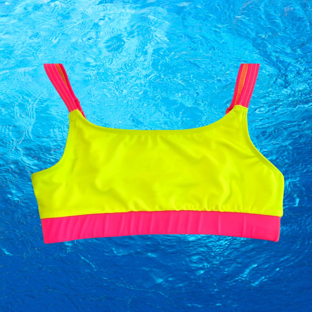 Bright swimwear line HiViz's neon bikini product images. The sporty bikini top is neon yellow with neon pink straps and band. The product image is on a blue water background. 