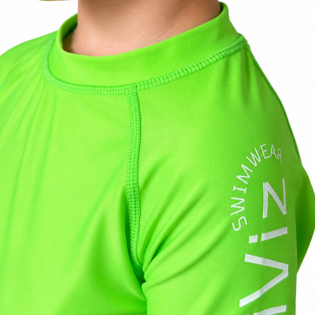 Close-up of a bright kids' neon green rash guard swim shirt with 'HIVIZ' branding on a white background