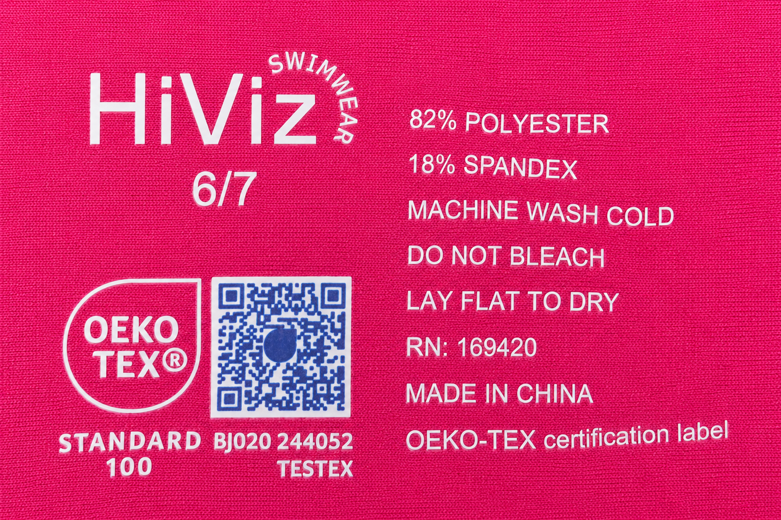 HiViz swimwear label with material information and OEKO-TEX ertification logos on a pink background