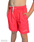 boys standing with his hands in his pockets, wearing hi viz neon pink swim trunks with a white hiviz swimwear logo on the right leg. 