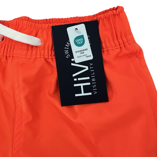 A close up of boys neon swim trunks with a HiViz tag and OEKO-TEX® tag.