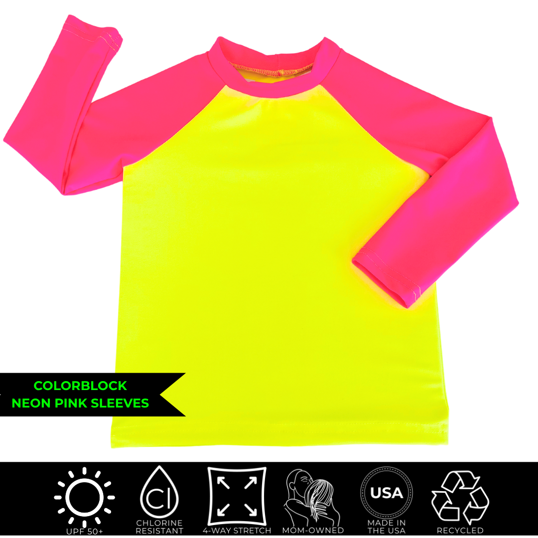 Product image of a neon yellow and neon pink rash guard. The body is neon yellow and the collar and raglan sleeves are neon pink. 